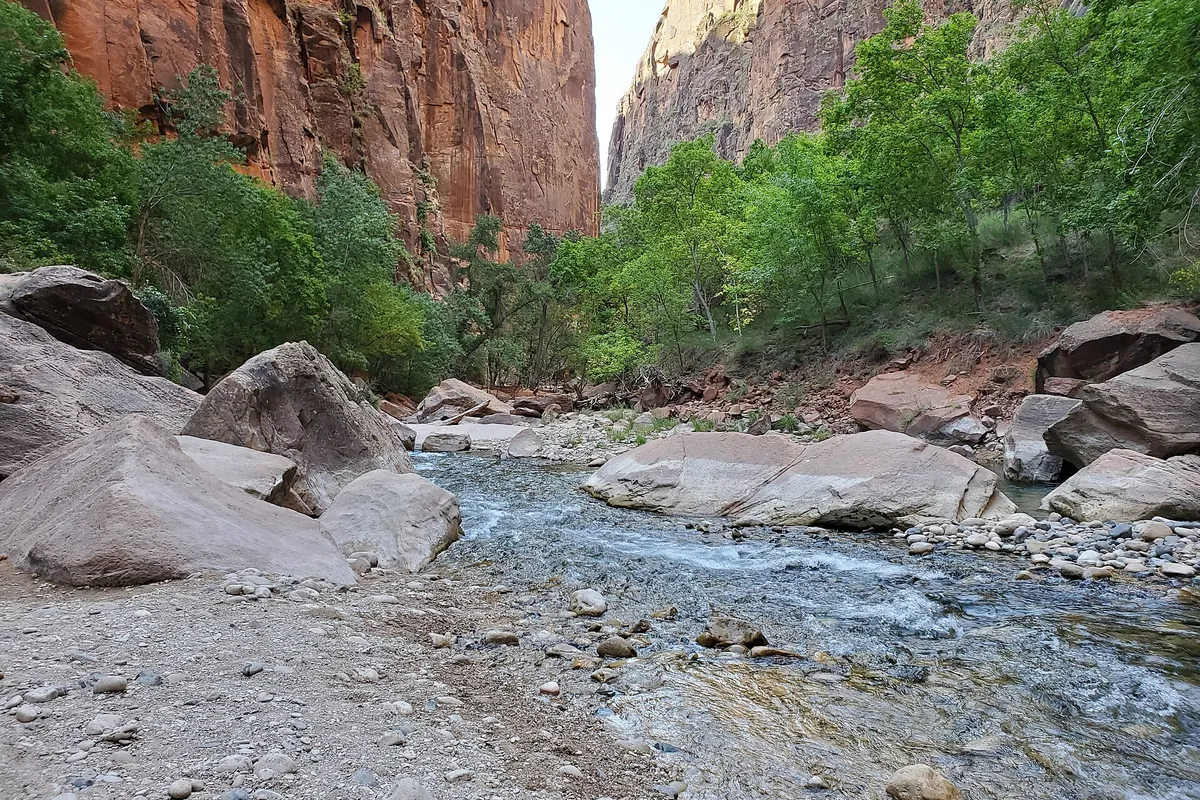 Virgin River flowing below red canyon walls near the Riverside Walk