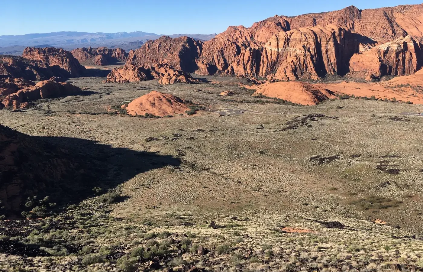 Red sandstone cliffs and desert scrub in the valley of Snow Canyon State Park near St. George