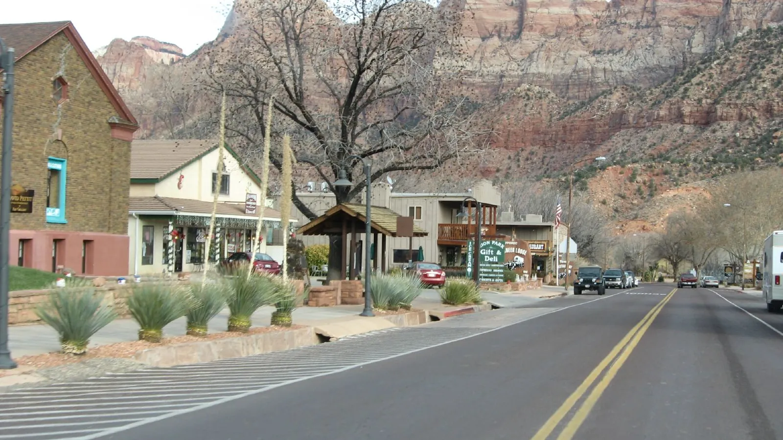 Main street in Springdale, Utah, with the red cliffs of Zion National Park rising behind the town