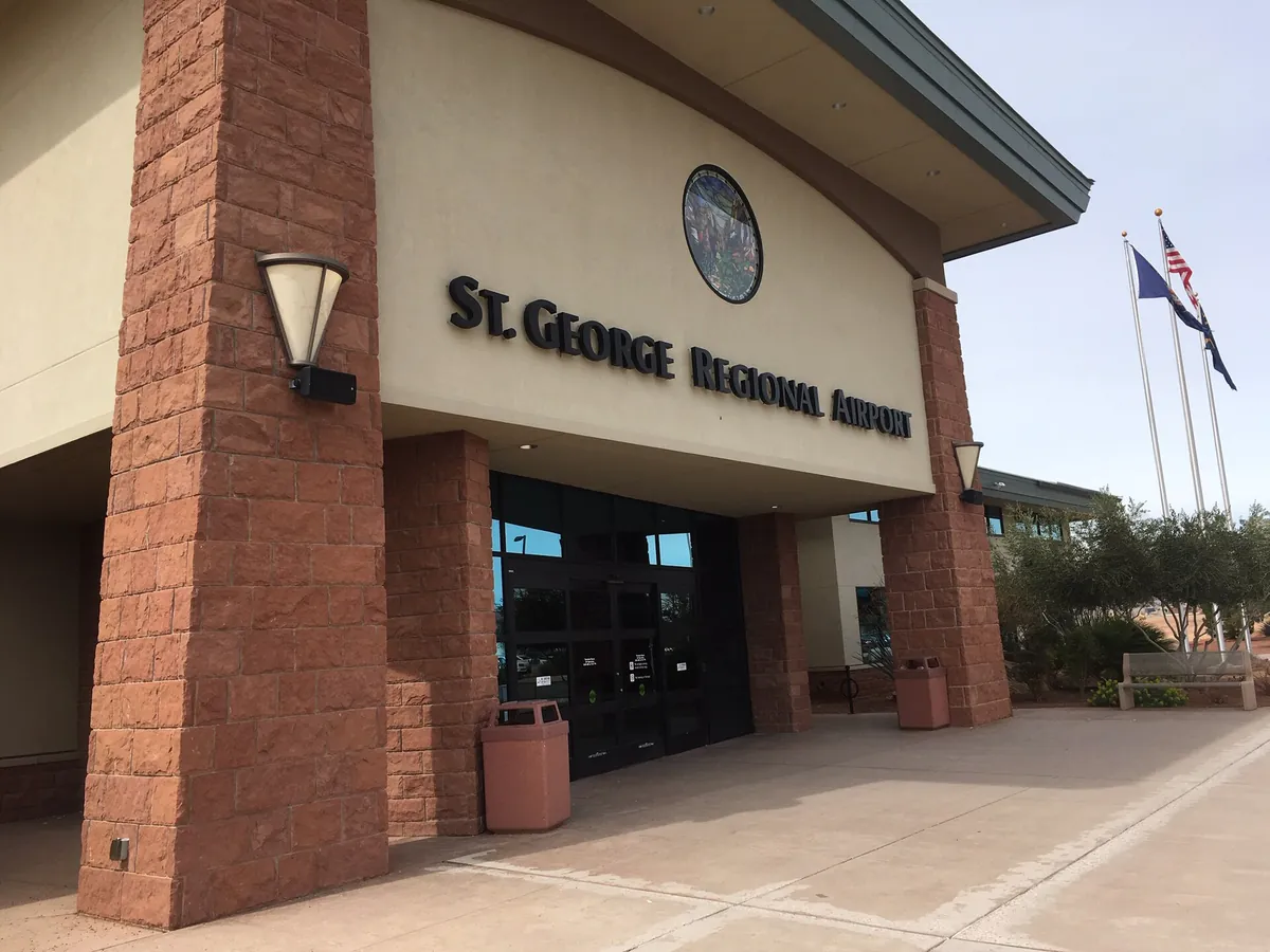 Entrance of the St. George Regional Airport terminal in southern Utah, with red stone columns and flags
