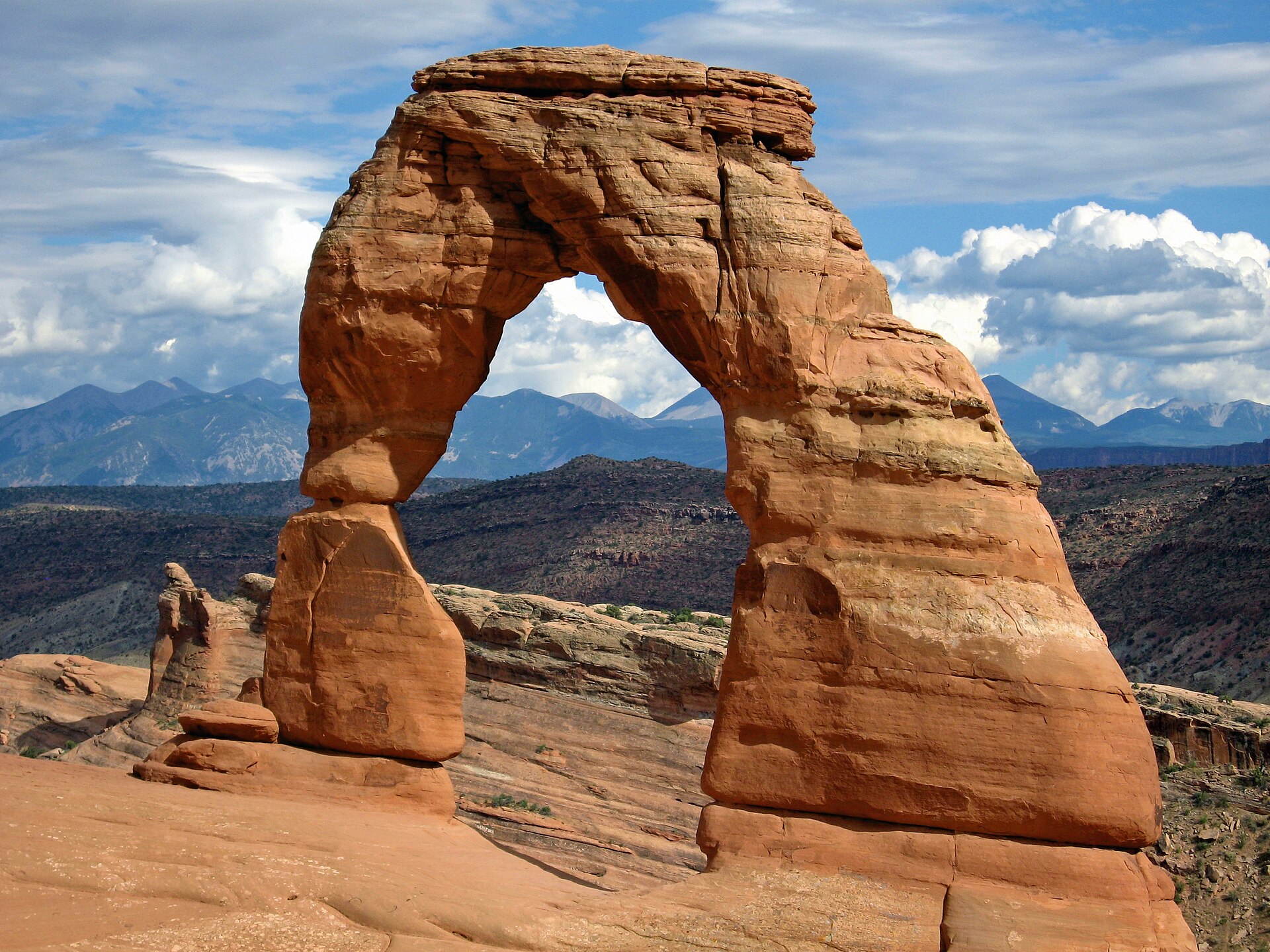 utah national parks road trip — Delicate Arch silhouetted against the sky at Arches National Park
