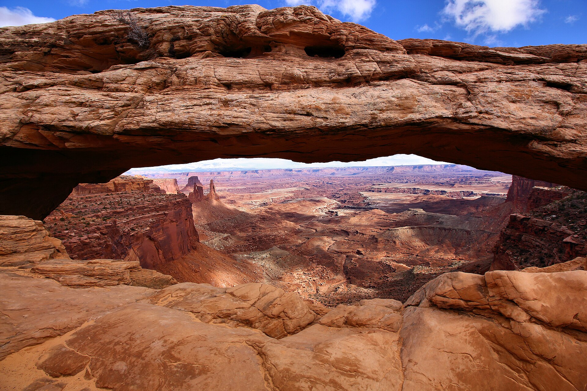utah national parks road trip — view through Mesa Arch over Canyonlands National Park's canyons