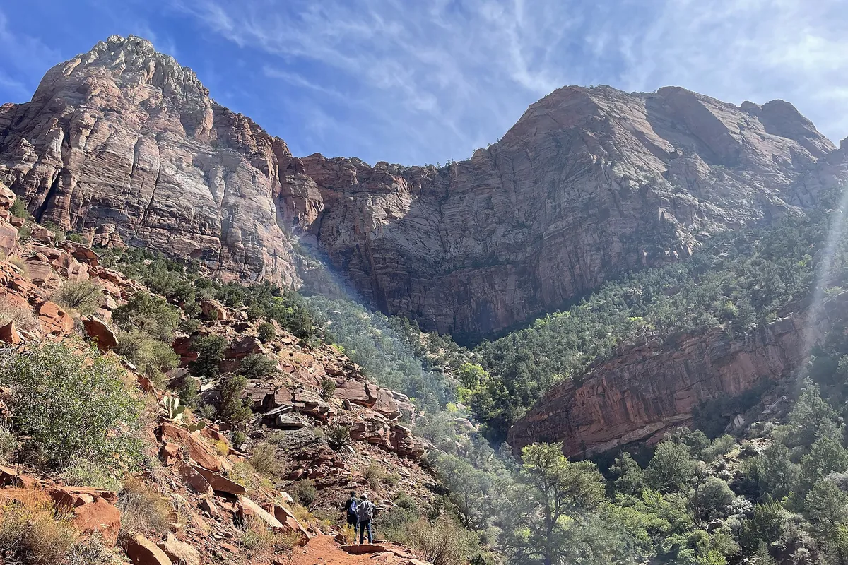 Canyon cliffs and a rocky slope seen from the Watchman Trail
